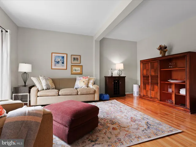 a living room with furniture a flat screen tv and closet