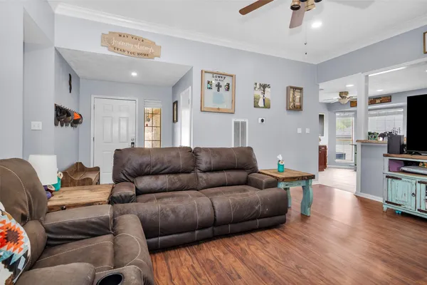 a living room with furniture and wooden floor