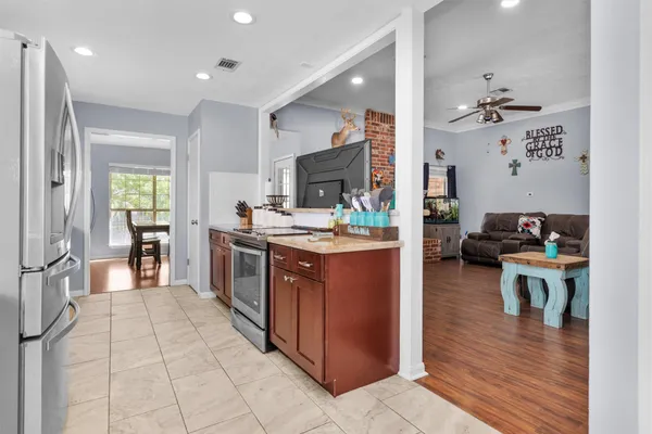 a large kitchen with stainless steel appliances granite countertop a sink and cabinets