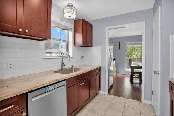 a kitchen with a sink a stove and cabinets