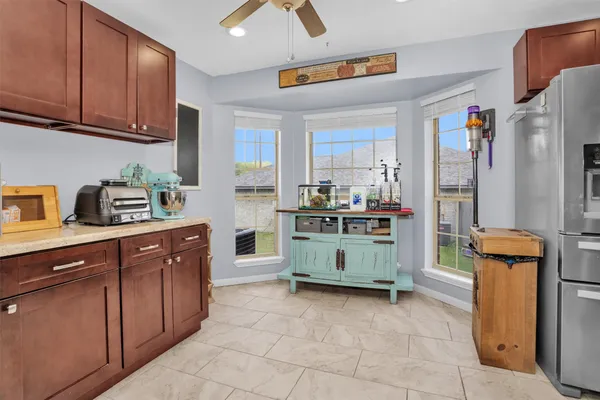 a kitchen with stainless steel appliances a stove a microwave a sink and cabinets