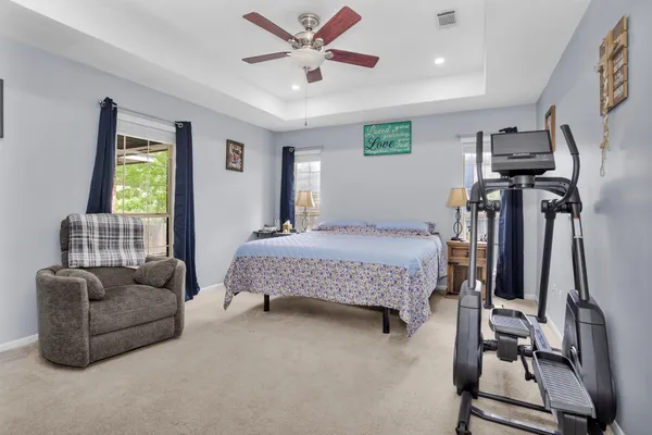 a bedroom with a bed couch and a window