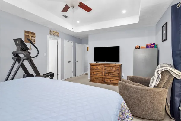 a bedroom with furniture and a flat screen tv
