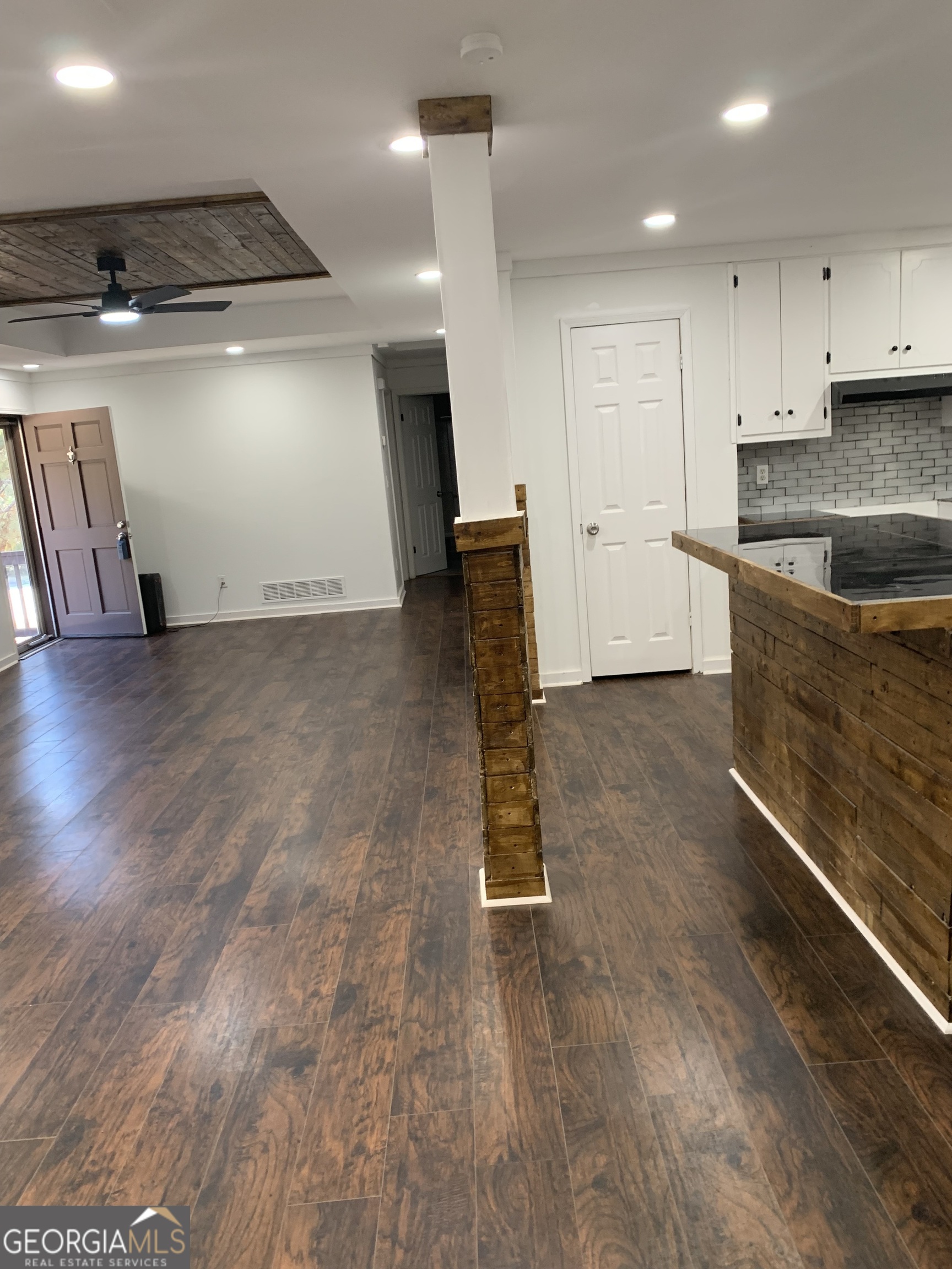 10167 Waterford Road Northeast Covington, GA 30014 - Photo 13 of 20 an empty room with wooden floor and windows