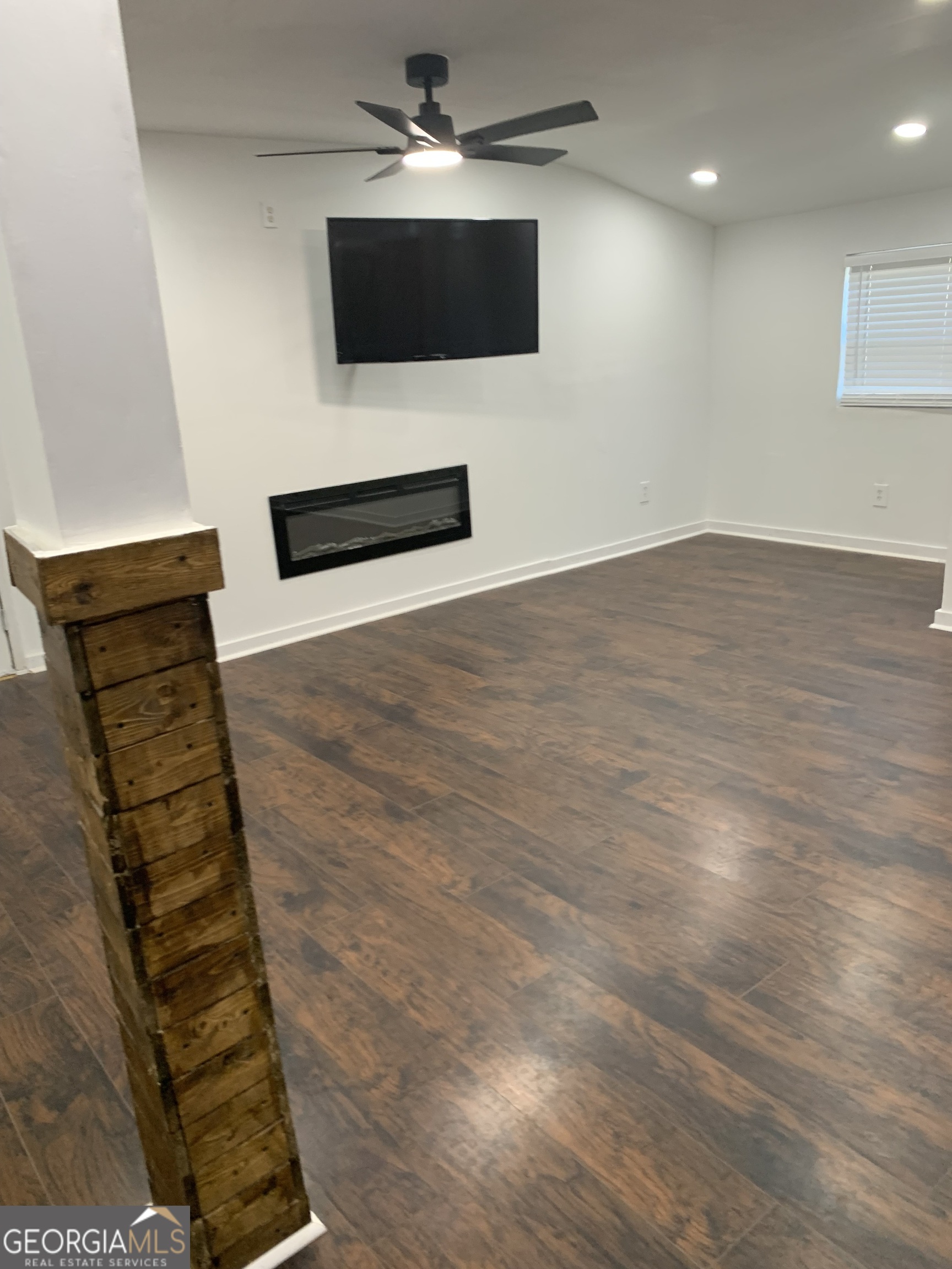 10167 Waterford Road Northeast Covington, GA 30014 - Photo 16 of 20 a living room with furniture and a flat screen tv