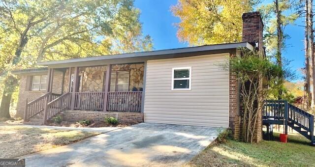 10167 Waterford Road Northeast Covington, GA 30014 - Photo 5 of 20 a view of a house with a small yard and wooden fence