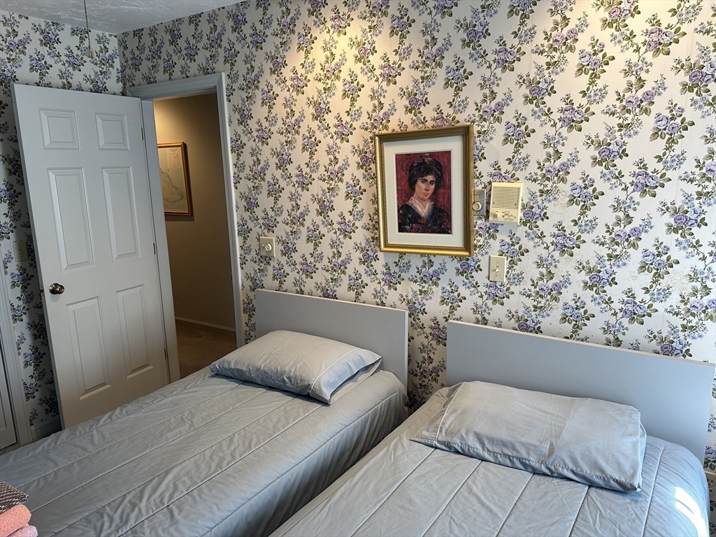 60 Captain Samadrus Road Cotuit, MA 02635 - Photo 31 of 41 a bedroom with a bed and a wall painting