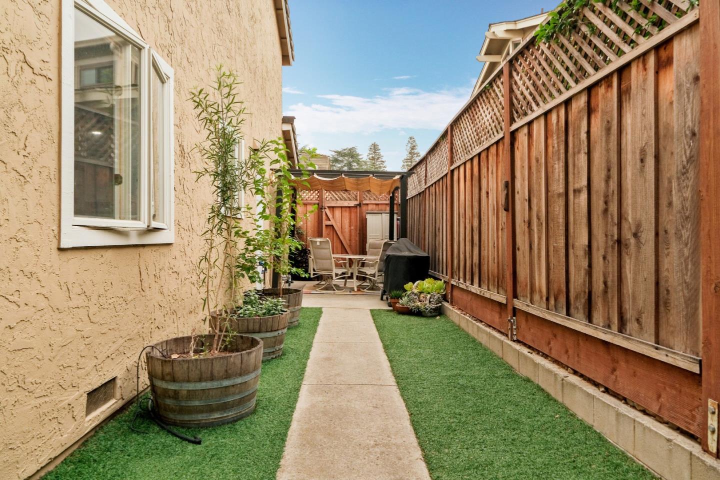 157 Redding Road Campbell, CA 95008 - Photo 20 of 31 a view of a back yard of the house with a chair and a potted plant