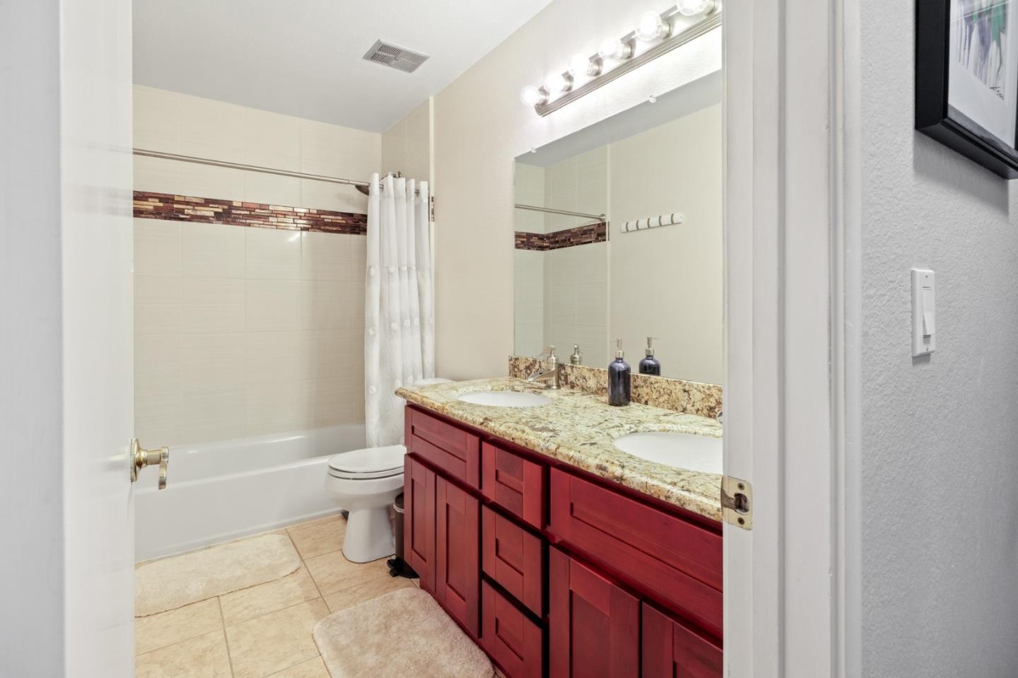 157 Redding Road Campbell, CA 95008 - Photo 25 of 31 a bathroom with a granite countertop sink toilet mirror vanity and shower