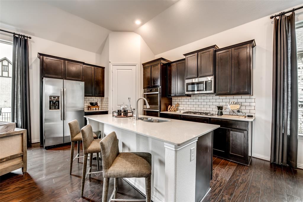 4798 Blackhawk Green Court Arlington, TX 76005 - Photo 11 of 16 a kitchen with stainless steel appliances a sink stove refrigerator and refrigerator