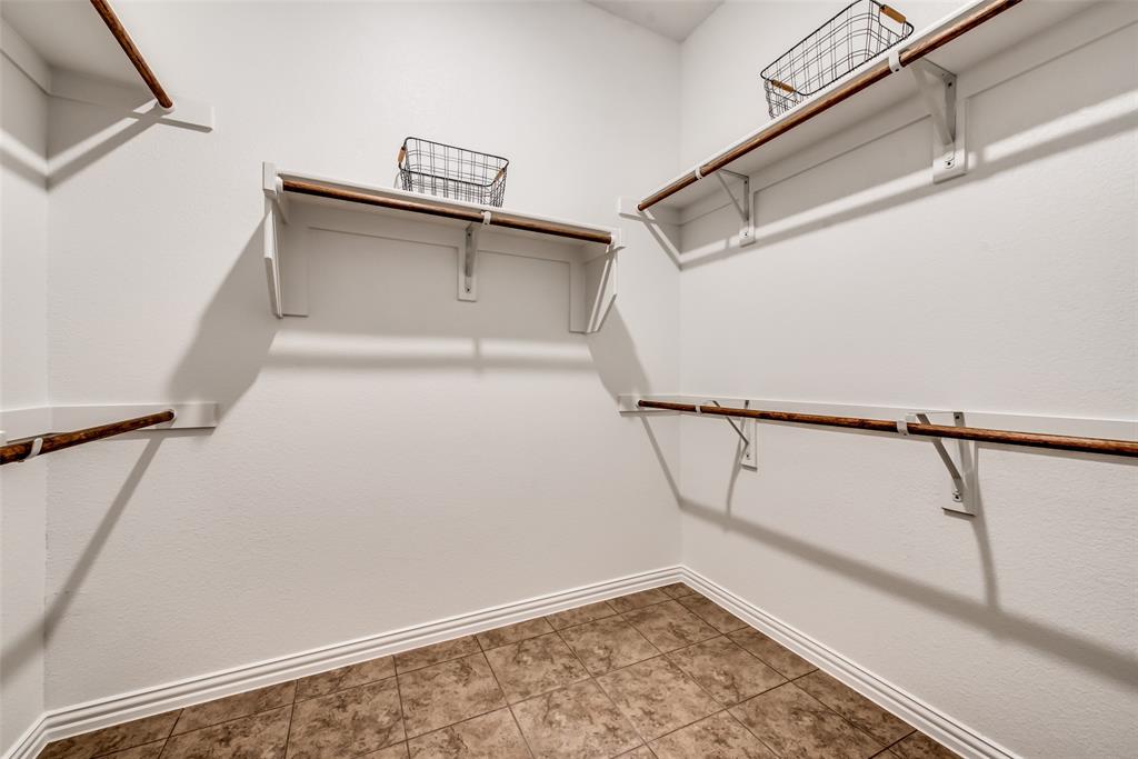 4798 Blackhawk Green Court Arlington, TX 76005 - Photo 3 of 16 a view of walk in closet with empty racks