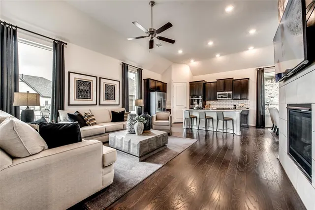 a living room with fireplace furniture and a flat screen tv