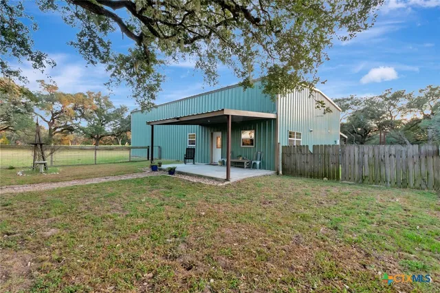 a view of a barn in the middle of a yard