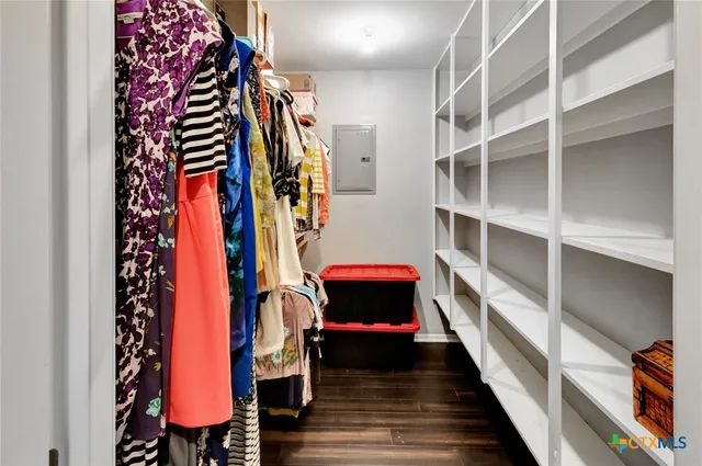 a view of walk in closet with clothes and shoes