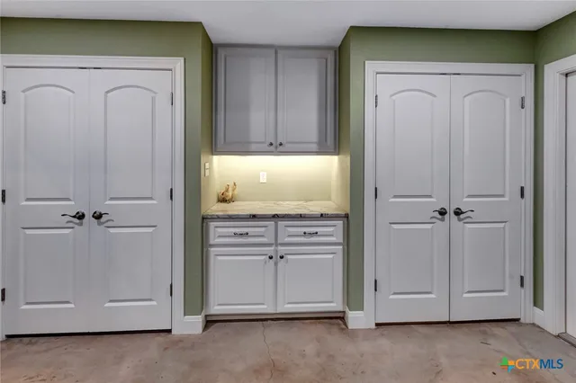 a living room with furniture a couch and lots of kitchen view