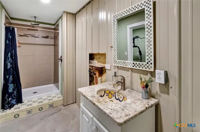 a spacious bedroom with a bed and a couch