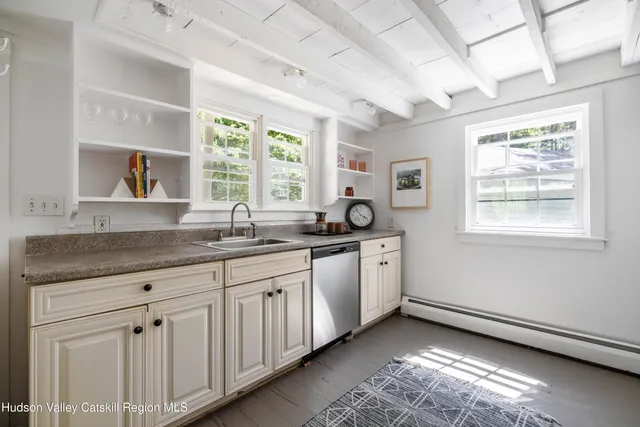a kitchen with sink window and cabinets
