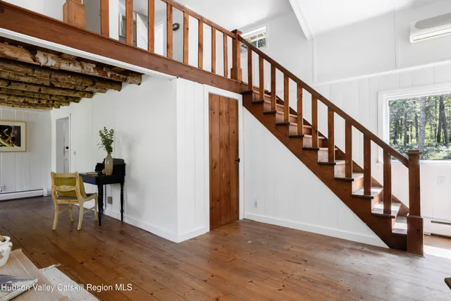 a view of entryway and hall with wooden floor