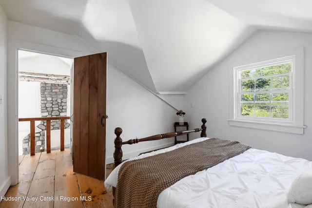 a bedroom with a large bed and a window