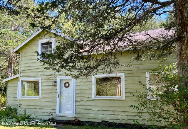 a front view of a house with trees
