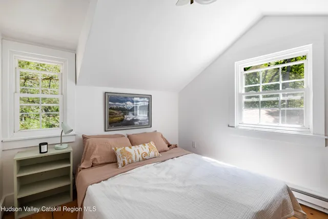 a bedroom with bed and a window