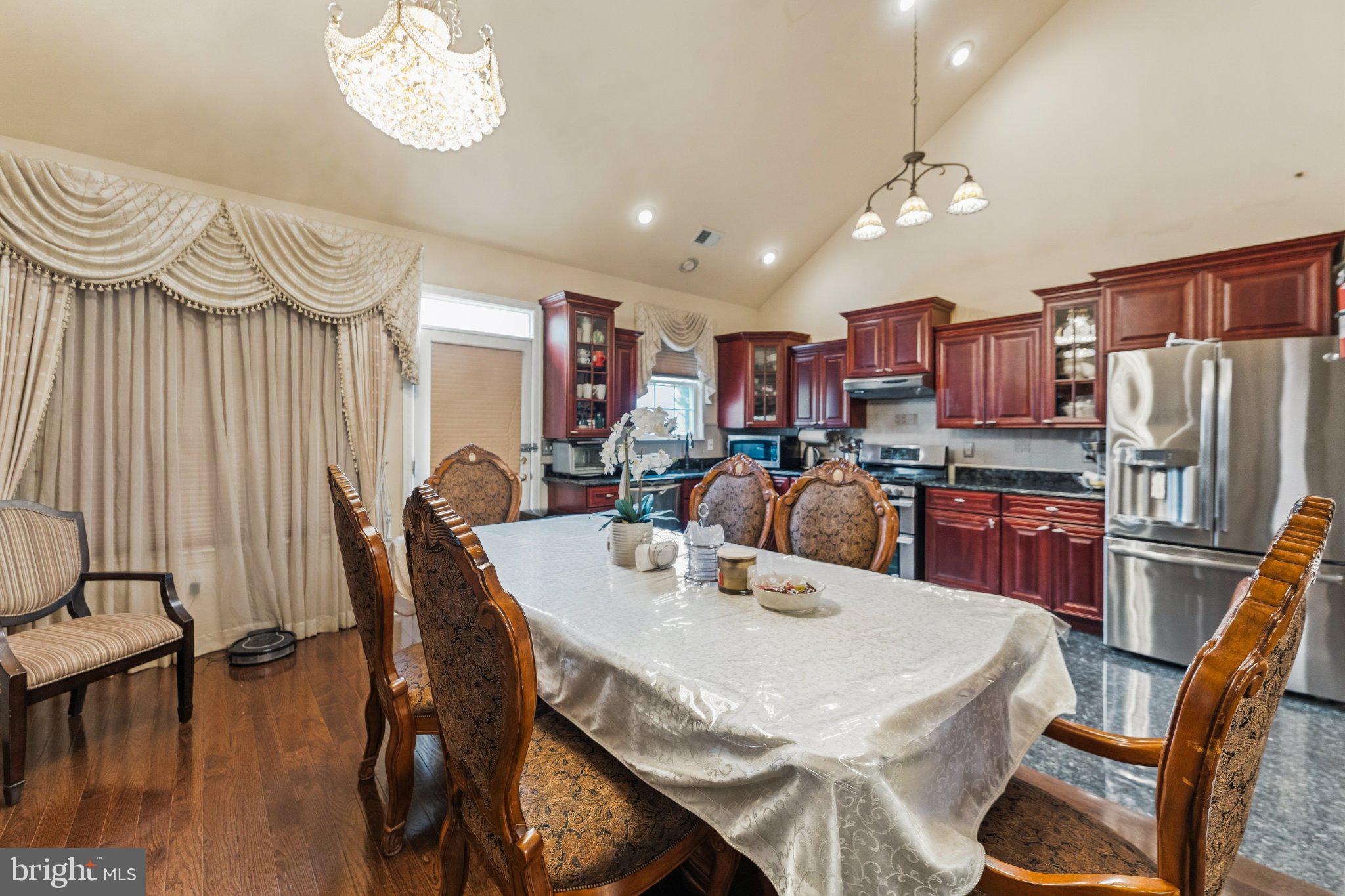 7 Spring Drive Dayton, NJ 08810 - Photo 6 of 24 a view of a dining room with furniture a kitchen and chandelier