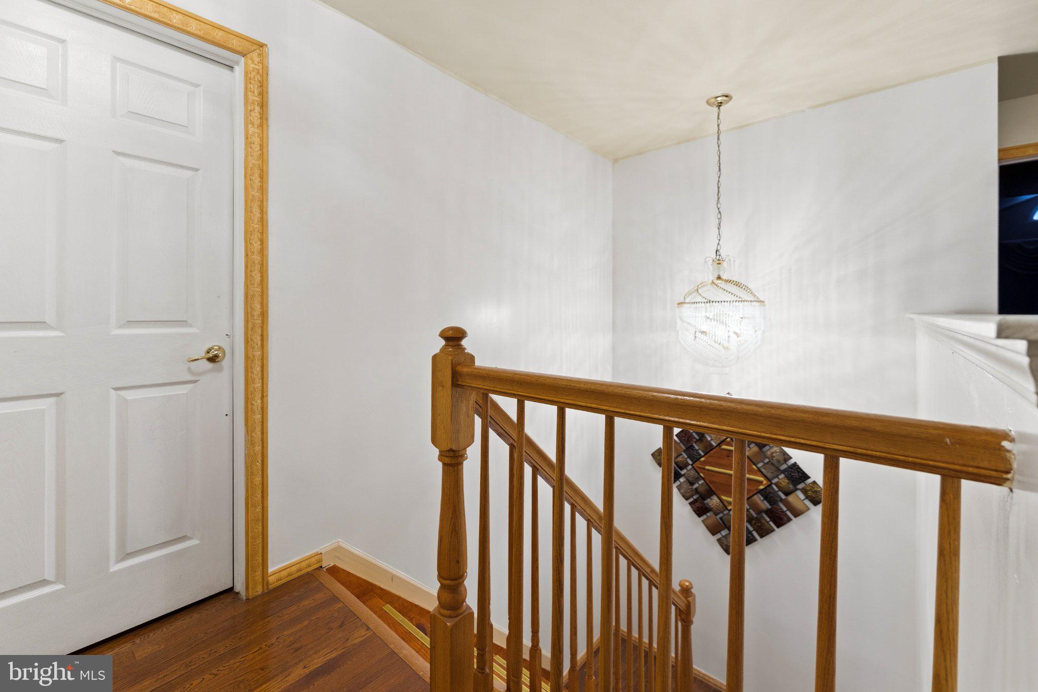 7 Spring Drive Dayton, NJ 08810 - Photo 9 of 24 a view of a hallway with wooden floor and staircase