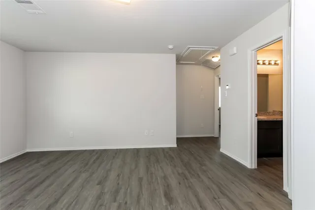 a view of a room with wooden floor