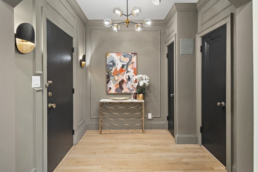 a view of a hallway with paintings on the wall
