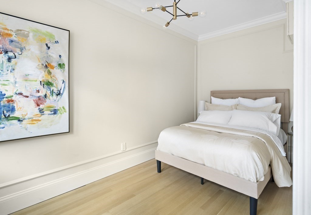 4 Chiswick Road, Unit 34 Boston, MA 02135 - Photo 13 of 22 a bedroom with a bed and painting on the wall