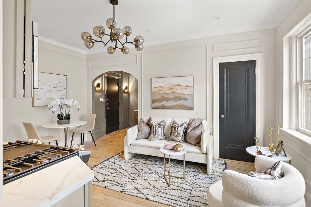 4 Chiswick Road, Unit 34 Boston, MA 02135 - Photo 2 of 22 a living room with furniture and a chandelier
