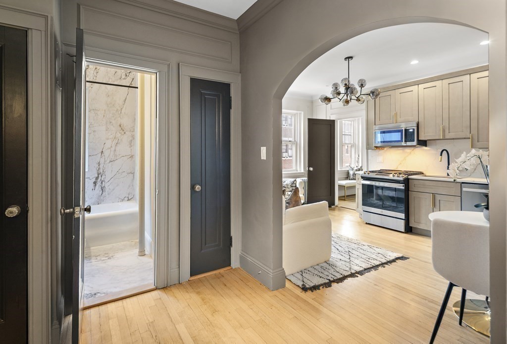 4 Chiswick Road, Unit 34 Boston, MA 02135 - Photo 6 of 22 a kitchen with kitchen island stainless steel appliances a sink and cabinets