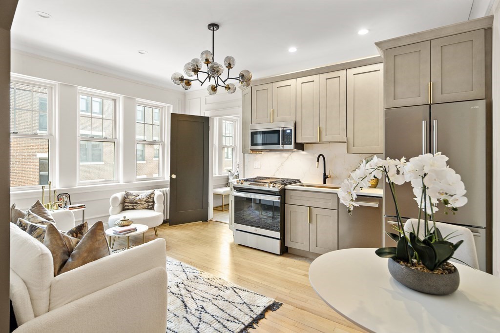 4 Chiswick Road, Unit 34 Boston, MA 02135 - Photo 7 of 22 a living room with stainless steel appliances kitchen island granite countertop furniture and a kitchen counter top