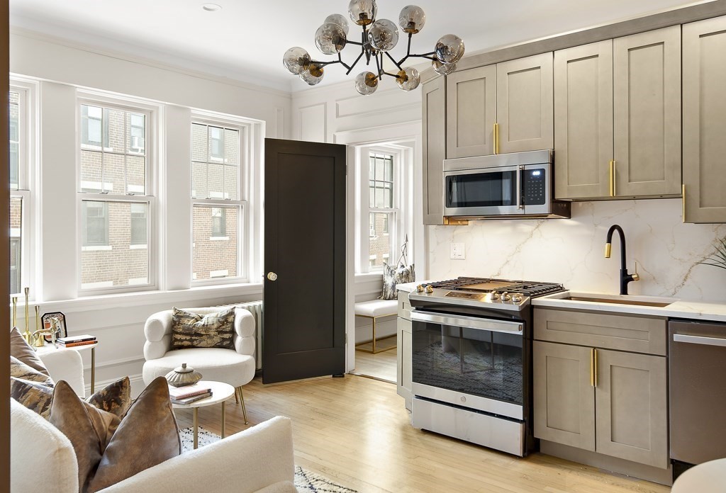 4 Chiswick Road, Unit 34 Boston, MA 02135 - Photo 8 of 22 a kitchen with stainless steel appliances granite countertop a stove microwave and refrigerator