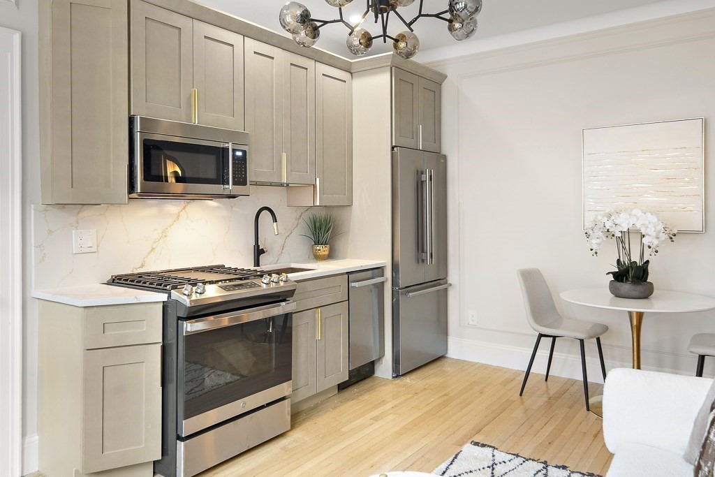 4 Chiswick Road, Unit 34 Boston, MA 02135 - Photo 9 of 22 a kitchen with stainless steel appliances a stove a microwave and a refrigerator