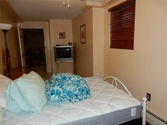 a bedroom with a bed and a television