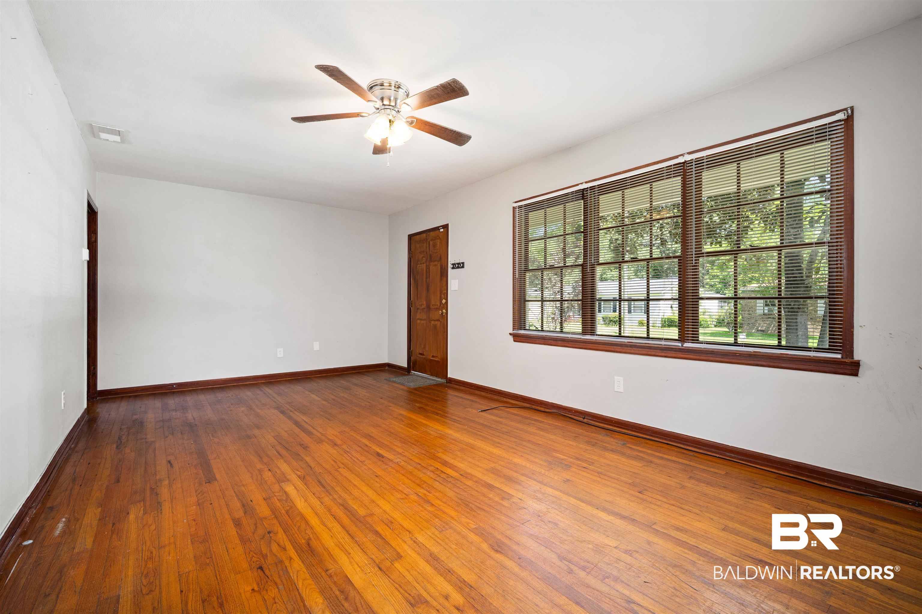 9 Elizabeth Avenue Mobile, AL 36611 - Photo 6 of 19 Empty room featuring ceiling fan and wood-type flooring
