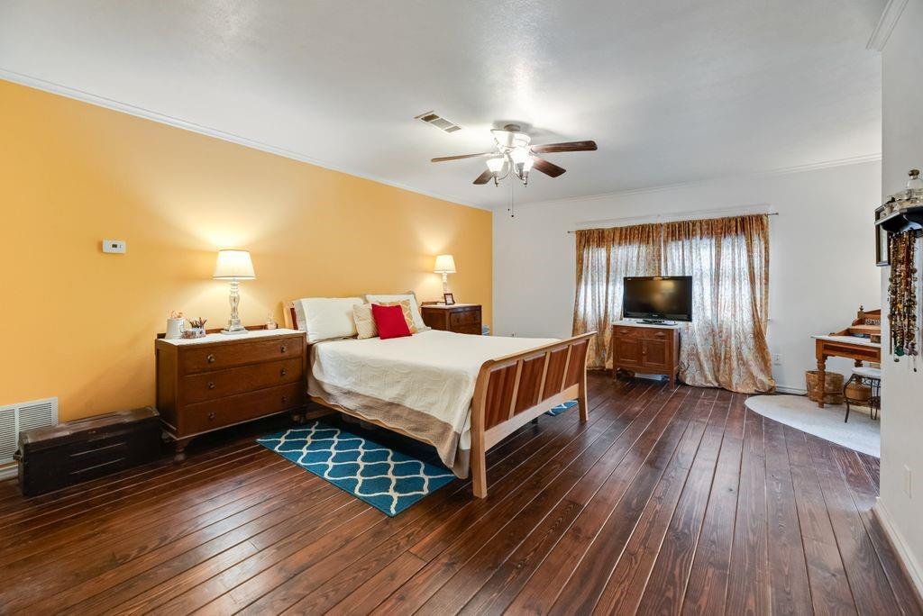9875 Old Bridge Road Terrell, TX 75160 - Photo 27 of 40 a bedroom with a bed and wooden floor