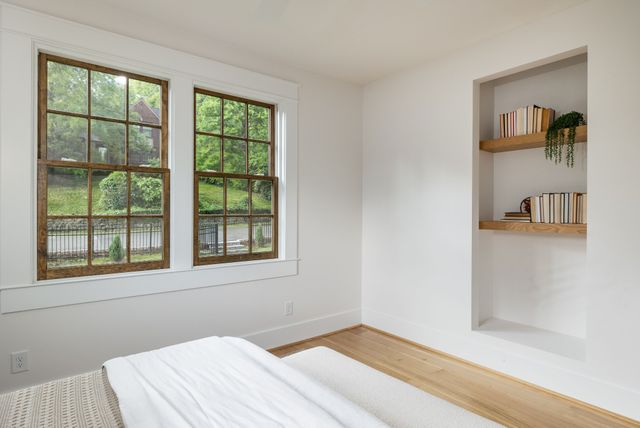 wooden floor in an empty room with a window