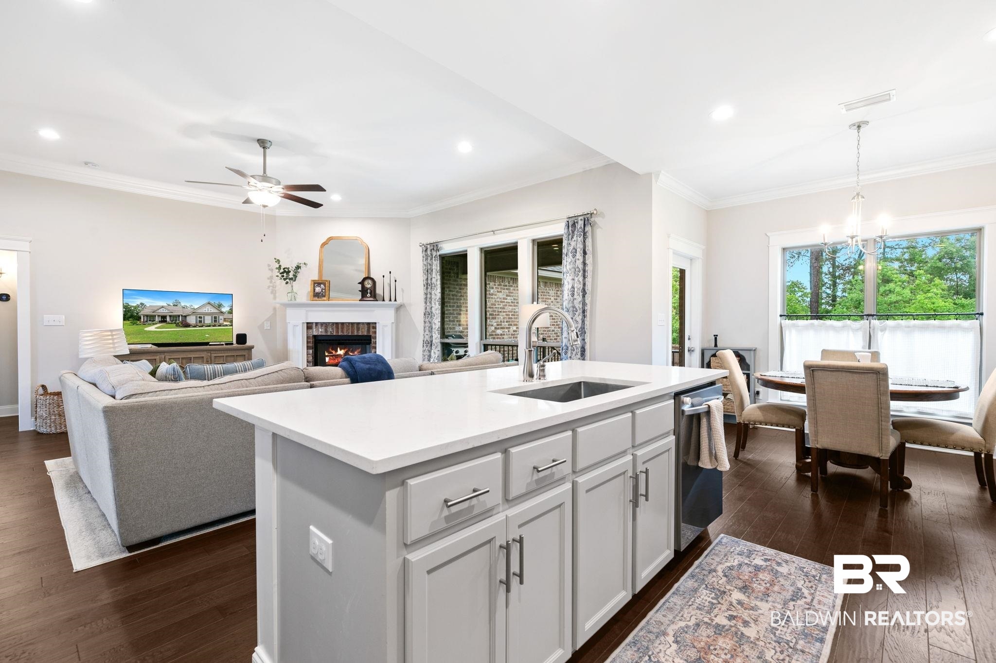 13233 Ibis Boulevard Daphne, AL 36527 - Photo 16 of 100 Open-concept living space featuring wood-finish flooring, recessed lighting, and a kitchen island with a built-in sink and white countertop