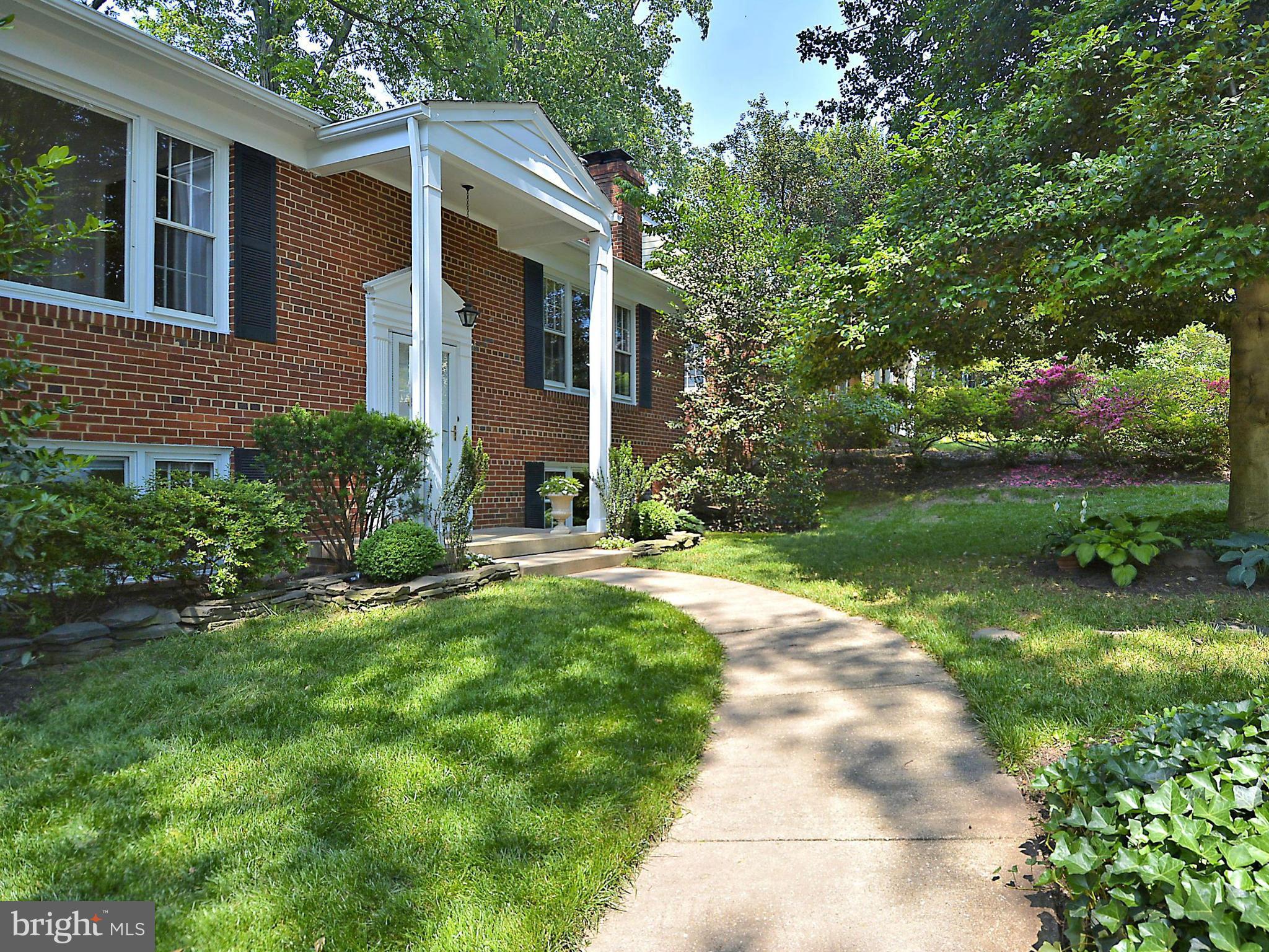 209 MacArthur Road Alexandria, VA 22305 - Photo 2 of 26 a front view of a house with garden