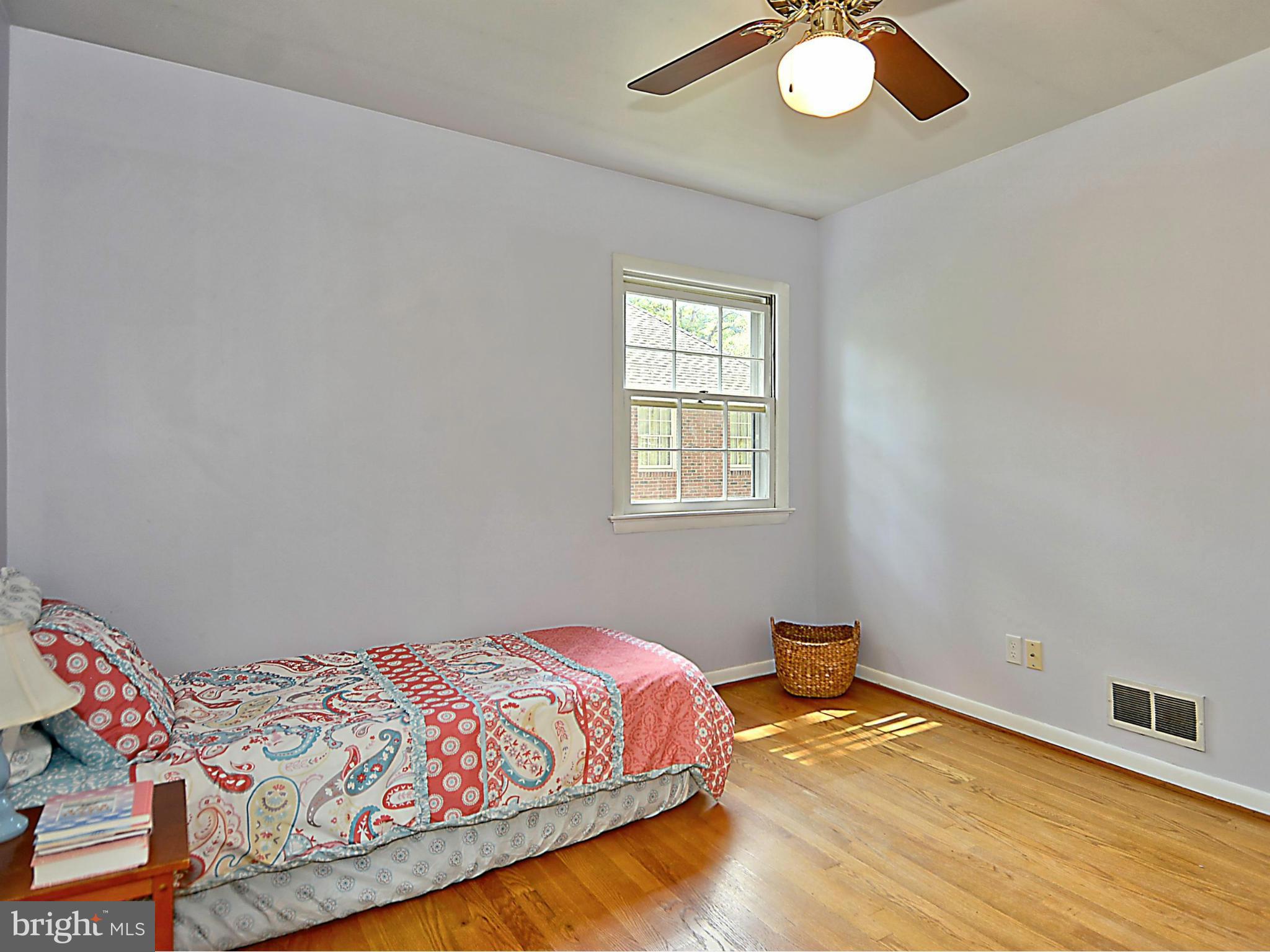 209 MacArthur Road Alexandria, VA 22305 - Photo 14 of 26 a bedroom with a bed and a chandelier