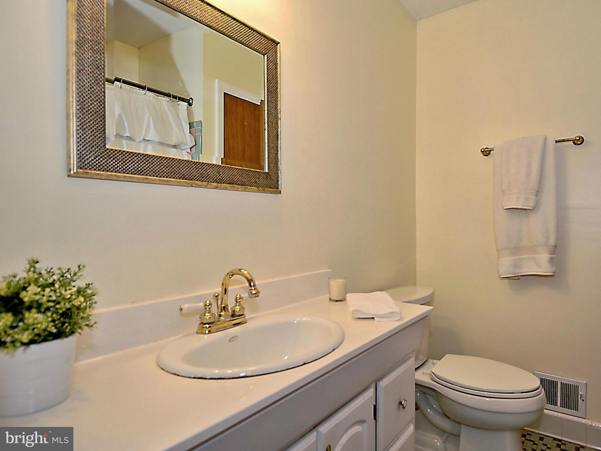 209 MacArthur Road Alexandria, VA 22305 - Photo 15 of 26 a bathroom with a sink mirror and toilet