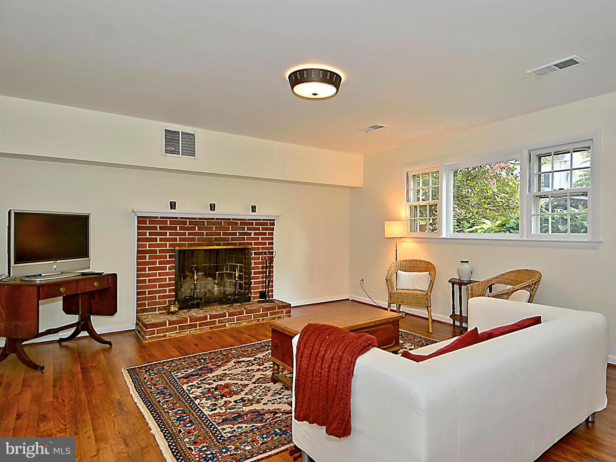 209 MacArthur Road Alexandria, VA 22305 - Photo 17 of 26 a bedroom with a bed and a fireplace