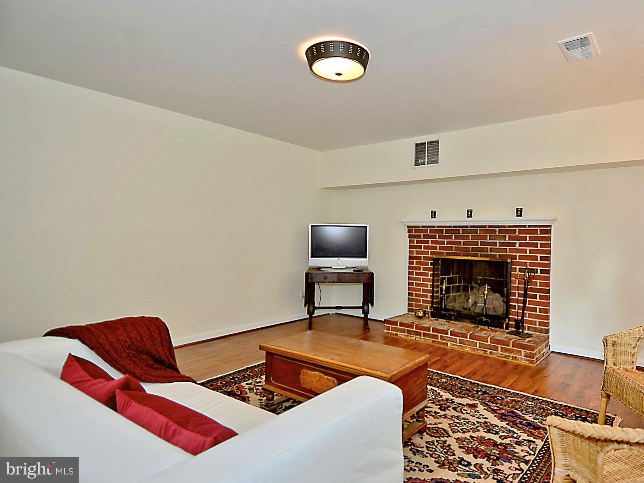 209 MacArthur Road Alexandria, VA 22305 - Photo 18 of 26 a living room with furniture and a fireplace