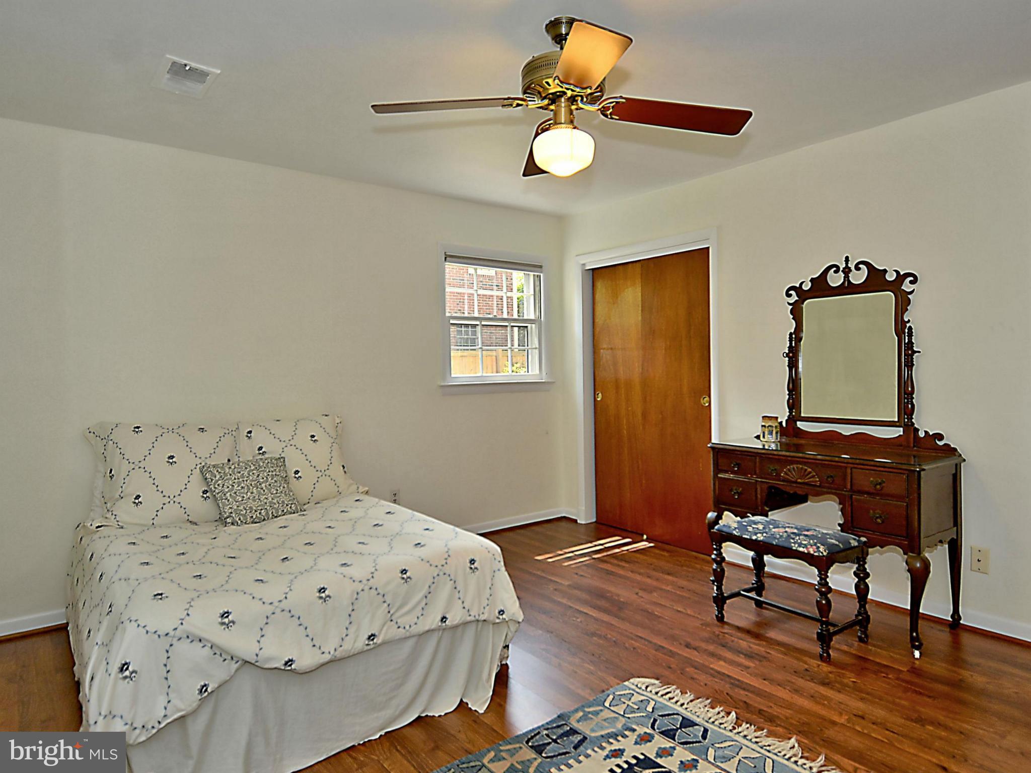 209 MacArthur Road Alexandria, VA 22305 - Photo 19 of 26 a bedroom with a bed and wooden floor