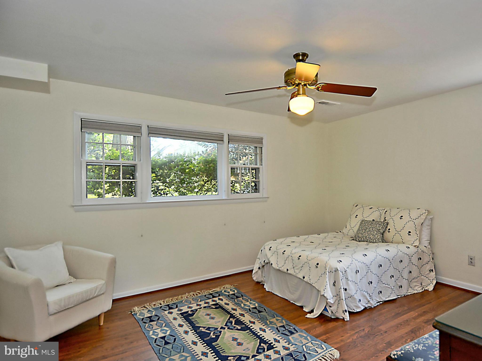 209 MacArthur Road Alexandria, VA 22305 - Photo 20 of 26 a bedroom with a bed and wooden floor