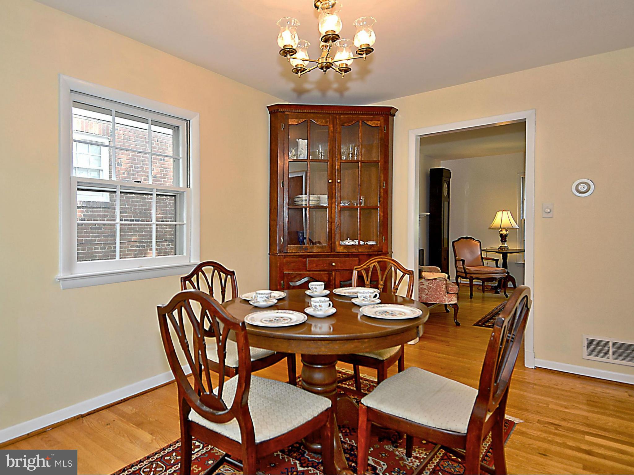 209 MacArthur Road Alexandria, VA 22305 - Photo 5 of 26 a view of a dining room with furniture window and wooden floor