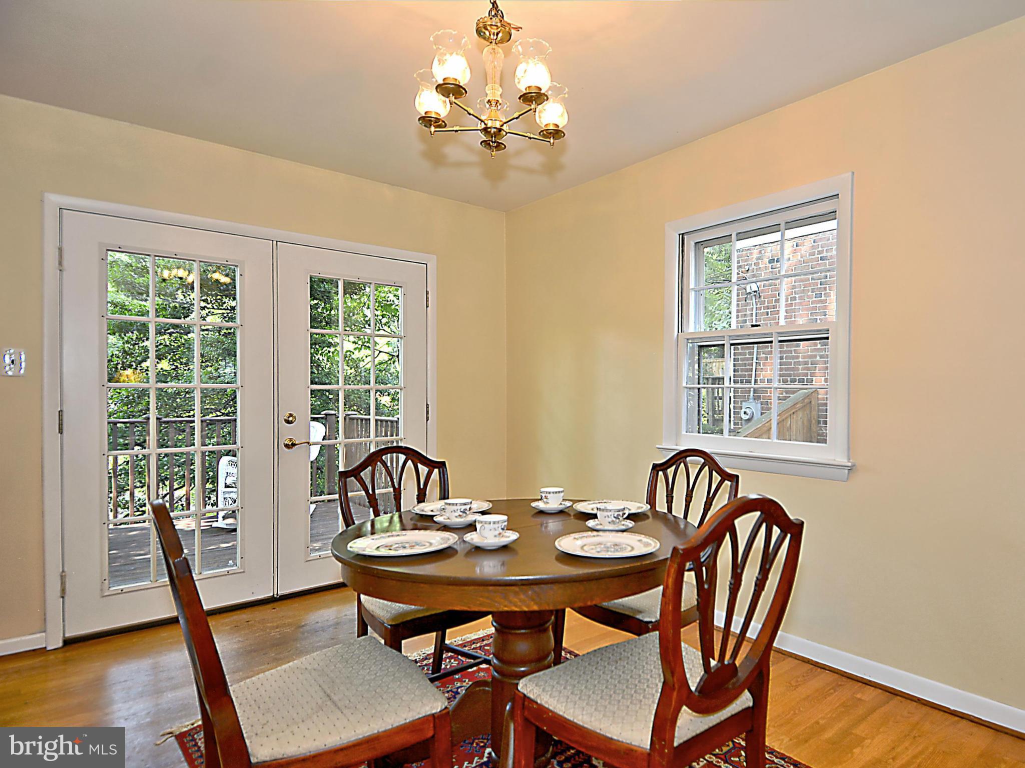209 MacArthur Road Alexandria, VA 22305 - Photo 6 of 26 a view of a dining room with furniture window and wooden floor