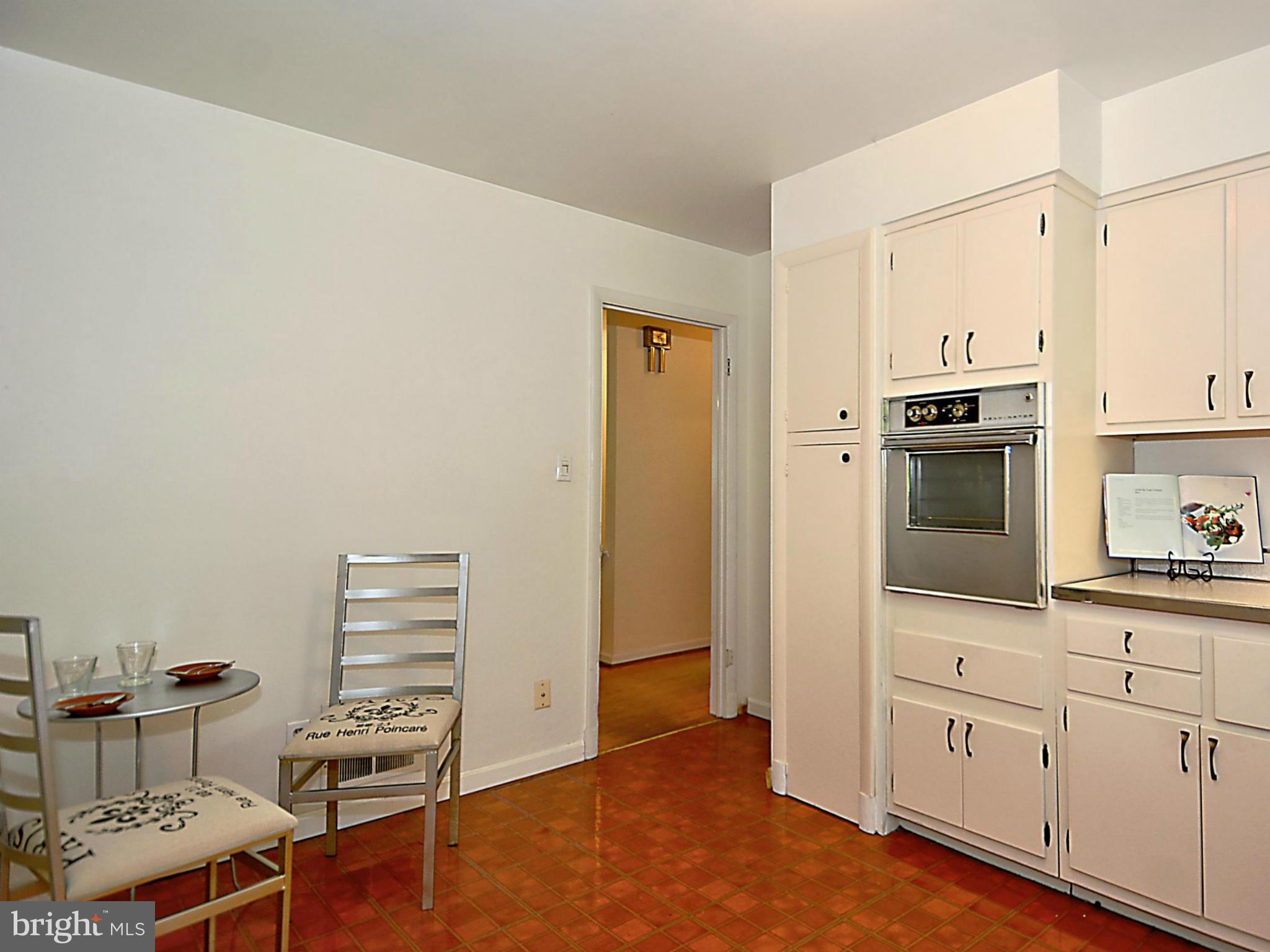 209 MacArthur Road Alexandria, VA 22305 - Photo 8 of 26 a kitchen with cabinets and wooden floor